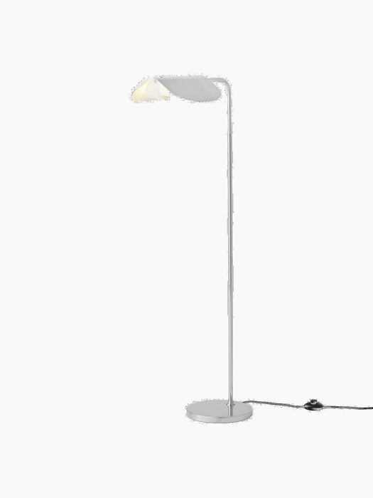 A switched-on Wing Floor Lamp in polished aluminium. It has a slender stem, a round base, and a rotating wing-shaped shade.