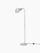 Angled view of the polished aluminium Wing Floor Lamp. The tall, minimal lamp features a round base and a wing-shaped shade.