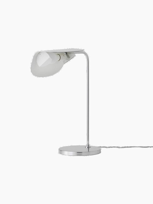 A tilted, side-angle view of the Wing Table Lamp in polished aluminium, showing its round base and wing-shaped shade.