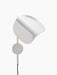 Side view of the Wing Wall Lamp in polished aluminium. The wing-shaped shade is tilted downwards, emitting a warm glow.