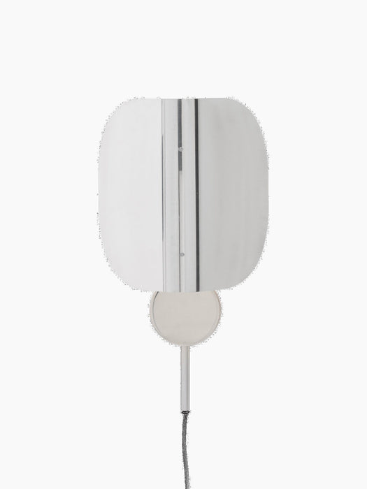 Front view of the Wing Wall Lamp in polished aluminium. The light is on, illuminating its folded, wing-like shade.