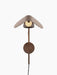 Front view of the turned-on Wing Wall Lamp in Bronzed Aluminium, featuring its wing-shaped shade over a glowing bulb.