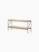 Angled view of the Zet Storage System, a two-level unit with natural oak shelves supported by a thin black steel frame.
