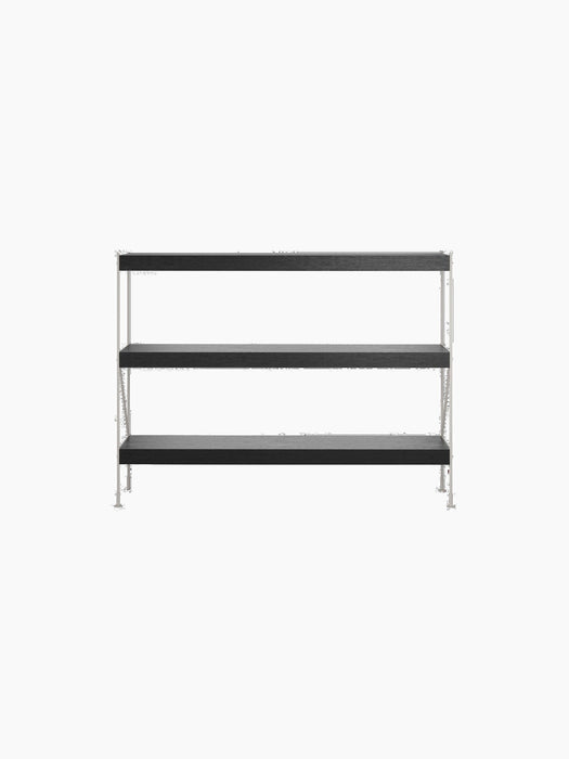 Front-facing view of the Zet Storage System, a three-tier shelving unit with black oak shelves and a slim, ivory steel frame.